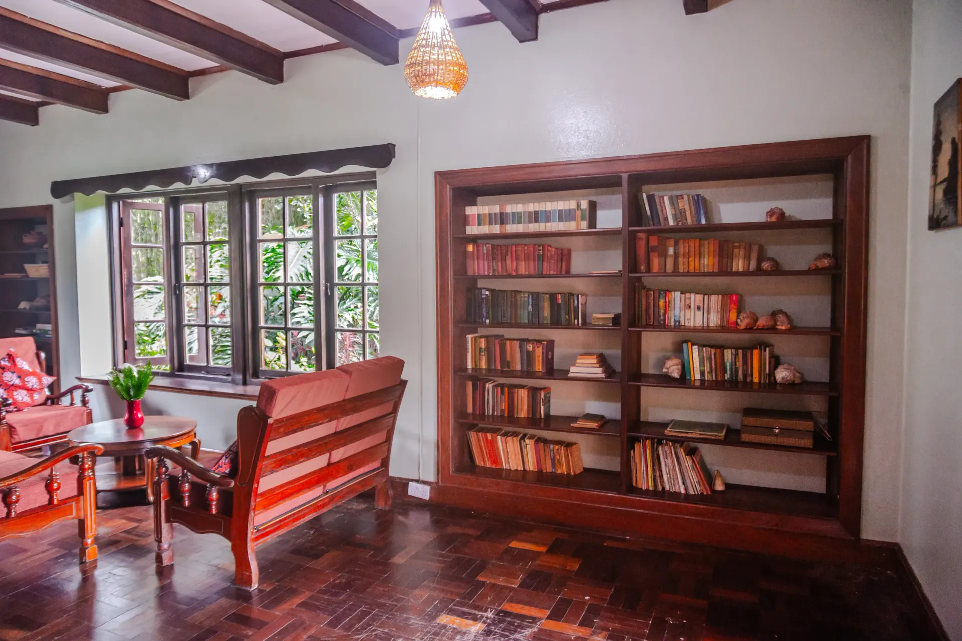 The library at Mullers — shelves of books, worn armchairs, a calm room for slow afternoons