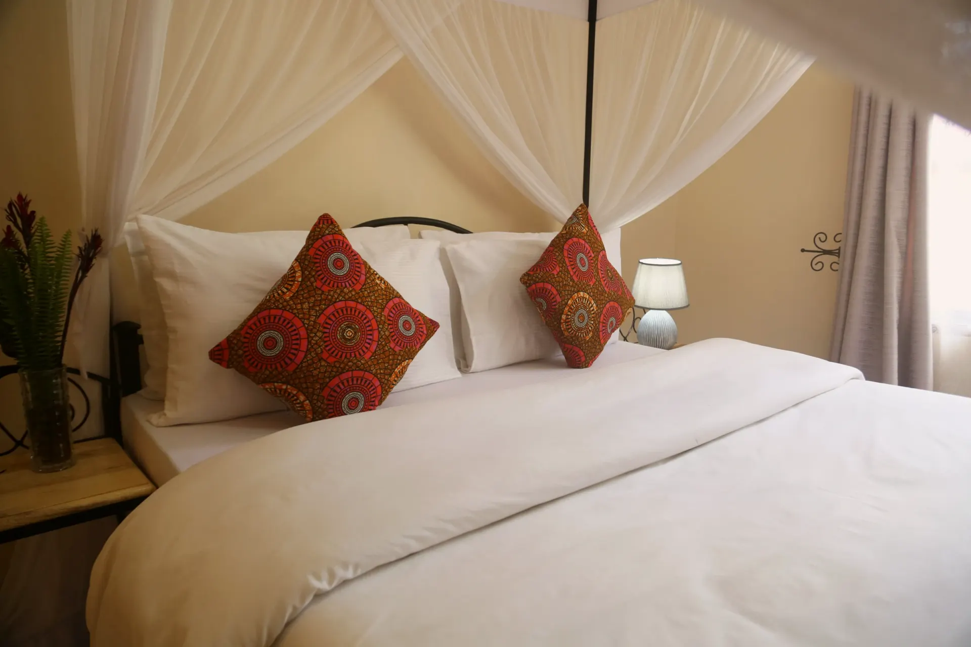 Bedroom A of Cottage 1, dressed in linen and warm wood