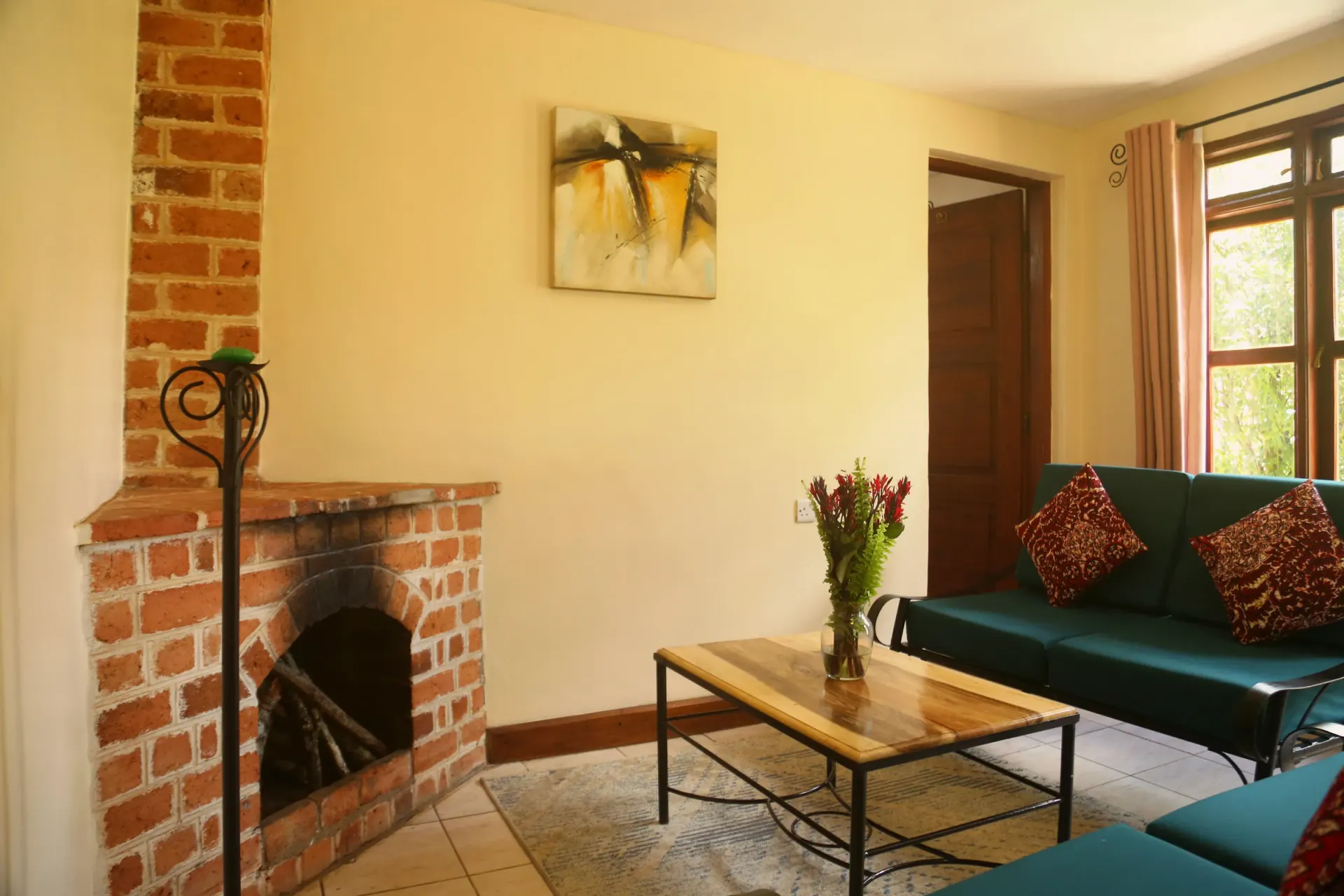 Bedroom A of Cottage 1, dressed in linen and warm wood