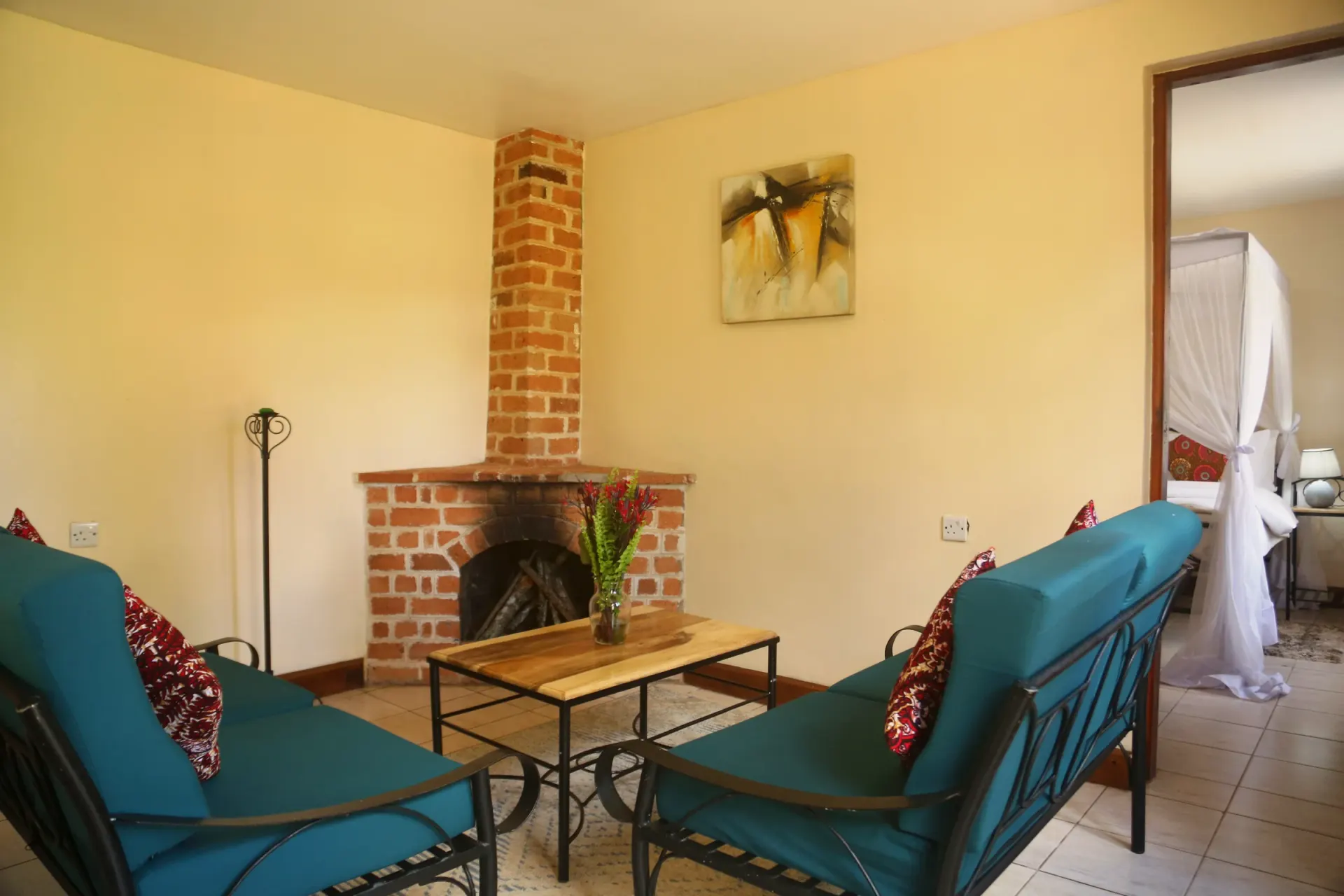 Bedroom A of Cottage 1, dressed in linen and warm wood