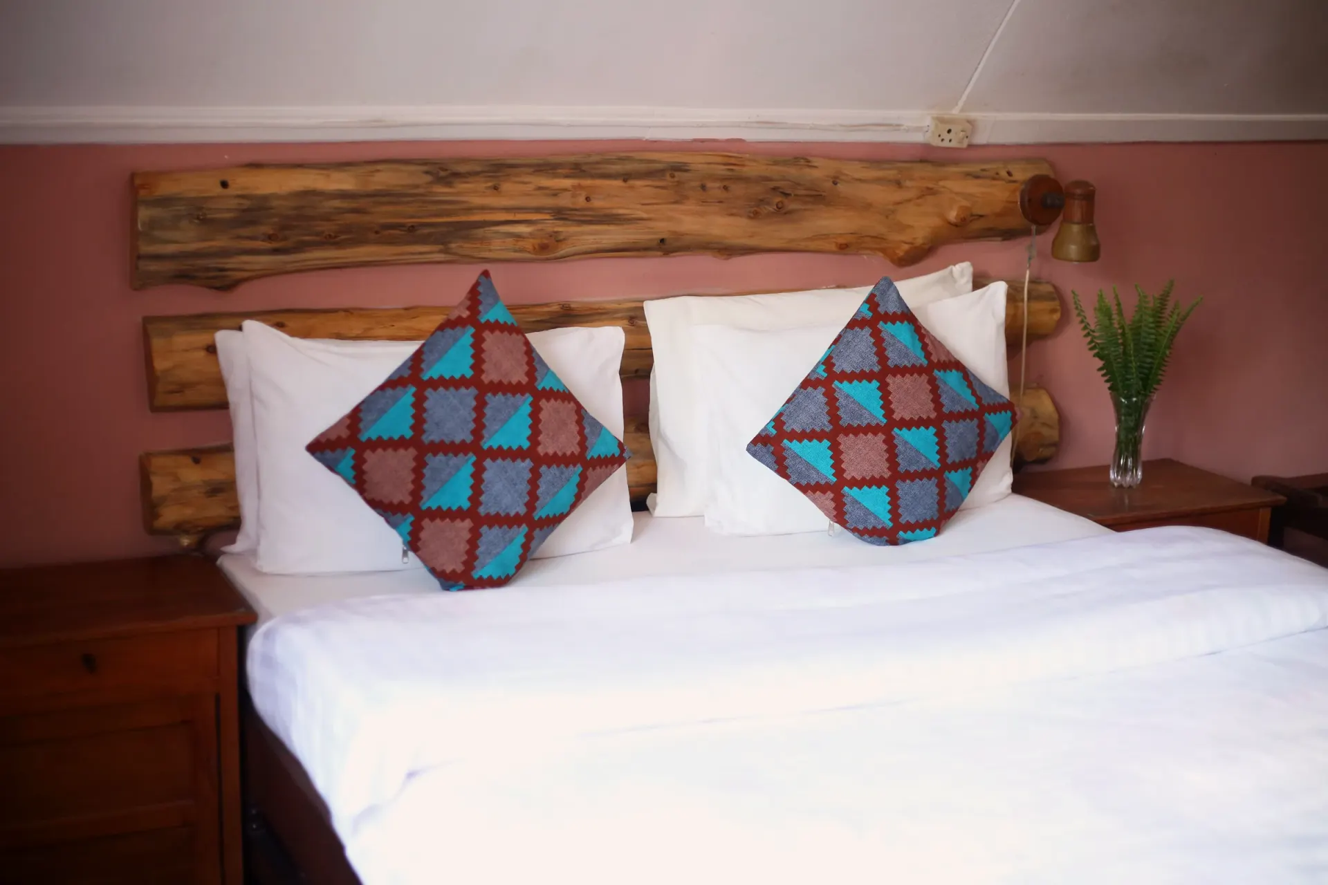 The first main-house bedroom at Mullers, dressed in warm linen