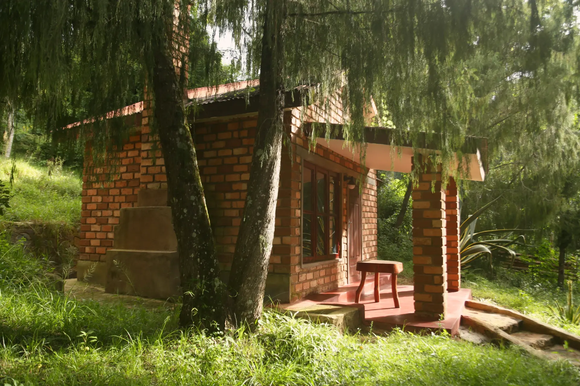The view room at Mullers — a bed framed by a window onto the Usambara hills
