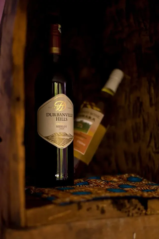 A bottle of Durbanville Hills merlot displayed in a carved wooden nook at the Mullers bar